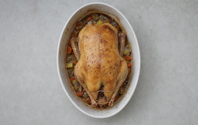 Roast Stuffed Duck, step 4: duck roasting with chopped vegetables