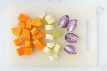 Seasoning the vegetables in a bowl with salt, paprika and olive oil
