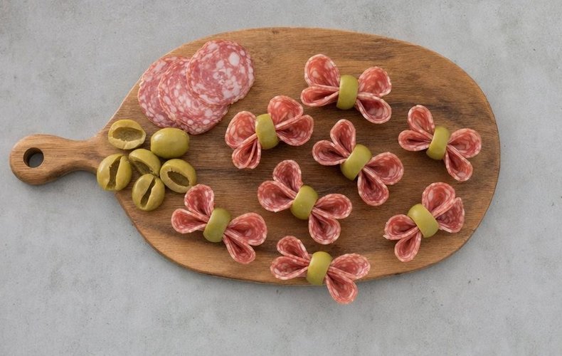 Salami and Olive Canapés, step 4: salami folded like an accordion and held in place by an olive