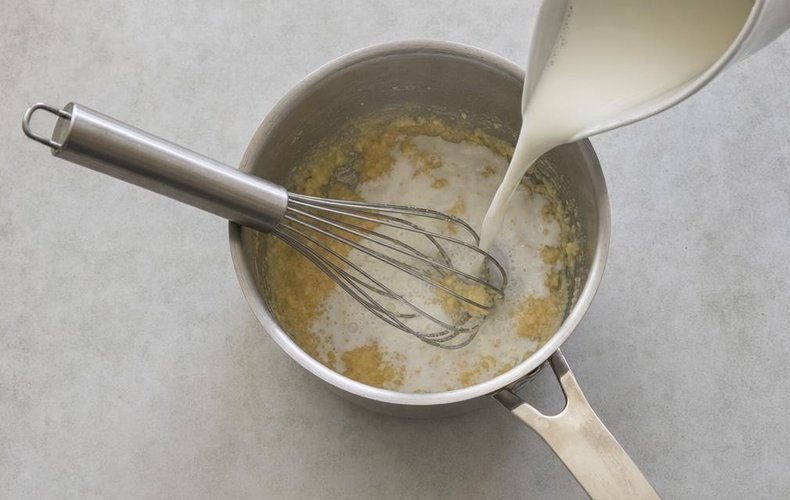 Salmon and Shrimp Lasagna, step 7: whisking the hot milk into the roux for the béchamel