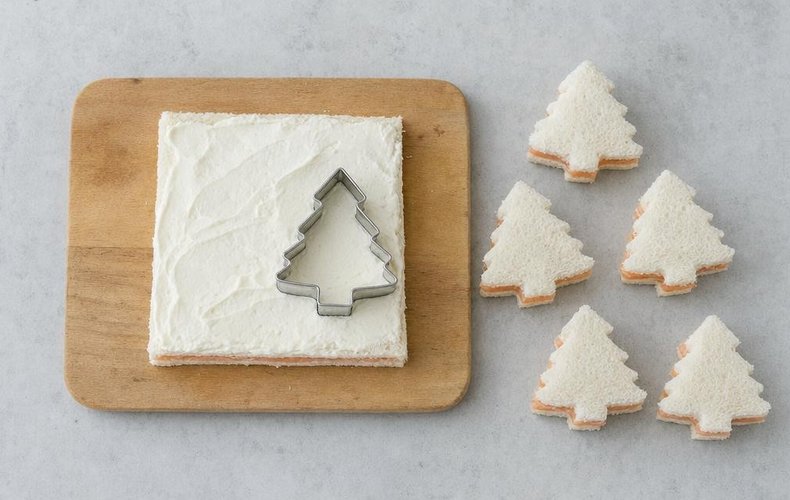Salmon and Pistachio Tramezzini Christmas Trees, step 4: cutting the filled bread with a Christmas tree cutter