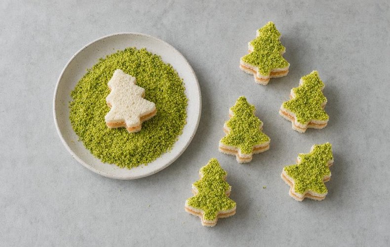 Salmon and Pistachio Tramezzini Christmas Trees, step 5: coating the little trees in ground pistachios