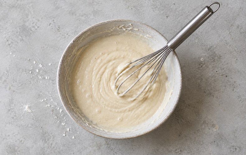 Salt Cod Fritters, step 2: whisking the water into the flour and yeast batter