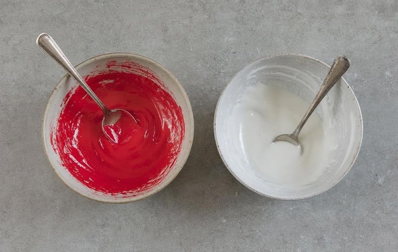 Santa's Mitten Cookies, step 7: the icing divided into two bowls, red and white