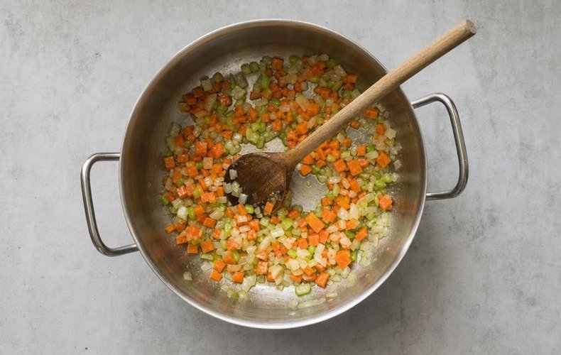 Sausage Ragù Lasagna, step 2: chopped carrot, onion and celery sautéing in olive oil