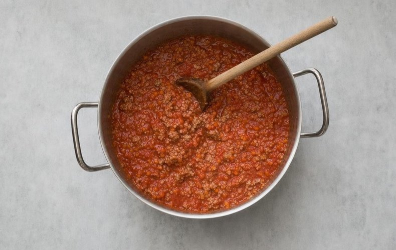 Sausage Ragù Lasagna, step 4: sausage ragù cooking with red wine and tomato puree