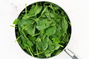 Spinach cooking in a skillet