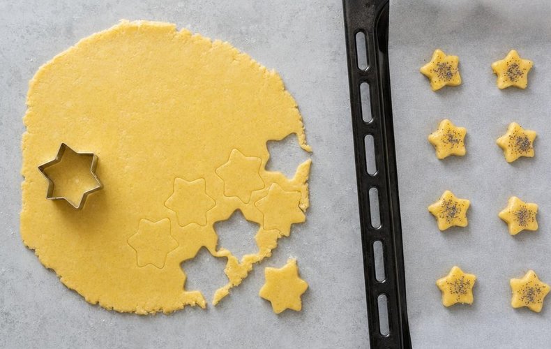 Savory Christmas Cookies, step 5: cookies cut out with Christmas cutters on a baking sheet
