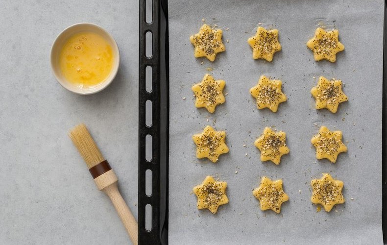 Savory Christmas Cookies, step 7: cookies brushed with egg and sprinkled with seeds and herbs