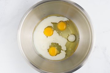 Whisking the oil and milk in a bowl
