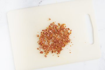 Chopping the crispy pancetta with a knife