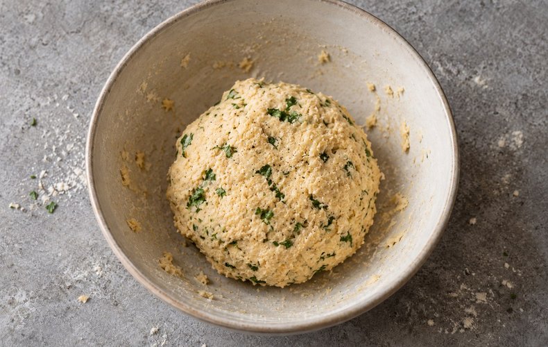 Savory Parmigiano Cookies, step 2: the dough kneaded by hand with egg and butter