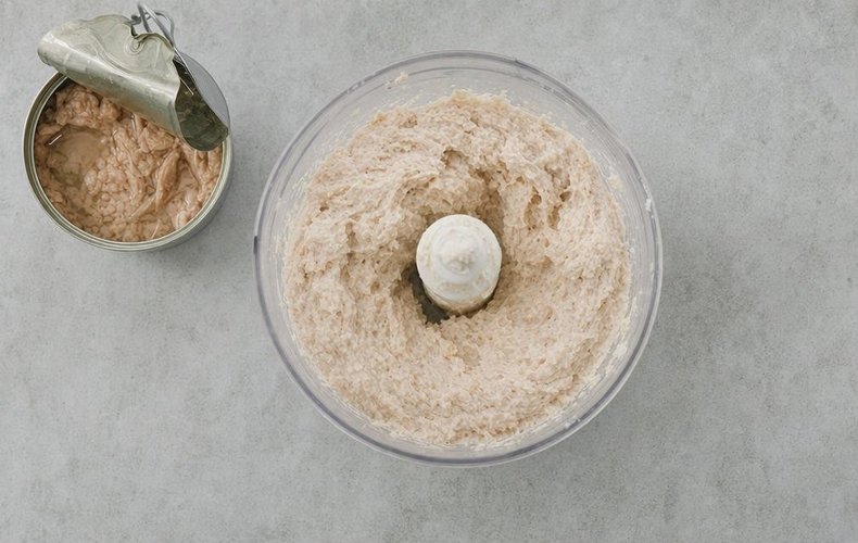 Blending the crumbs with cream cheese and tuna