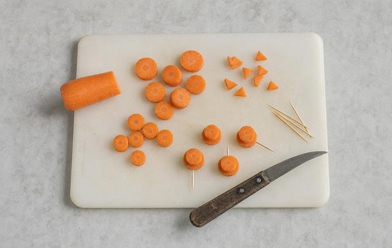 Carrot rounds and triangles for the hats and noses