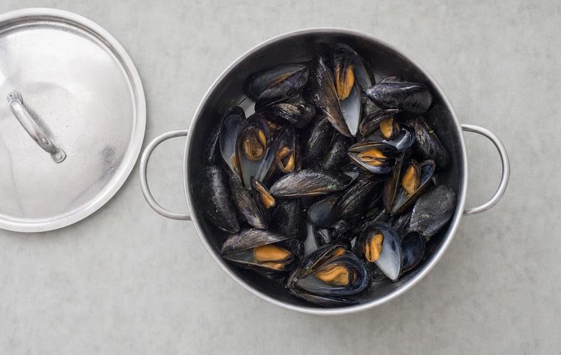 Seafood Salad, step 3: mussels opening in a covered skillet