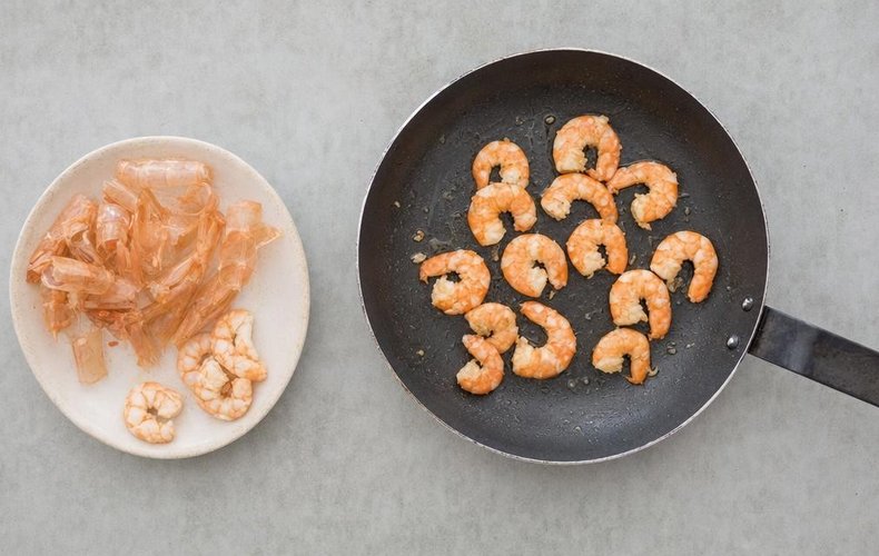 Seafood Salad, step 4: shrimp cooking in a skillet until pink