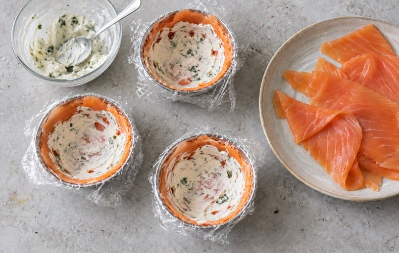 Spreading parsley cream cheese over the salmon