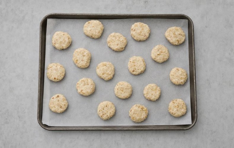 Snowball Cookies, step 4: balls of dough on a baking sheet lined with parchment paper