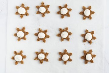 Piping the goat cheese onto the snowflakes