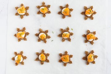 Snowflake crostini sprinkled with chopped chives