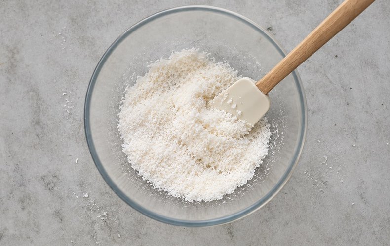 Soft Coconut Macaroons, step 1: desiccated coconut and sugar in a bowl