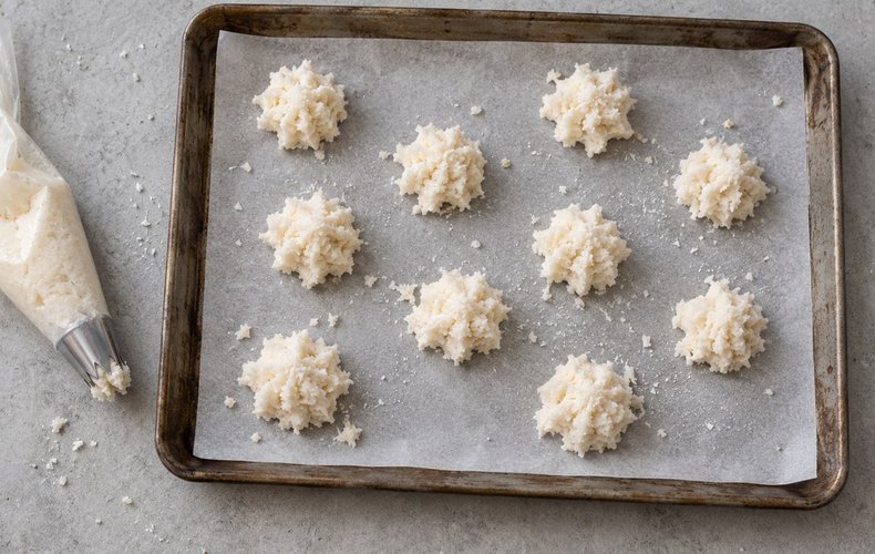 Soft Coconut Macaroons, step 3: small mounds piped onto a baking sheet lined with parchment paper