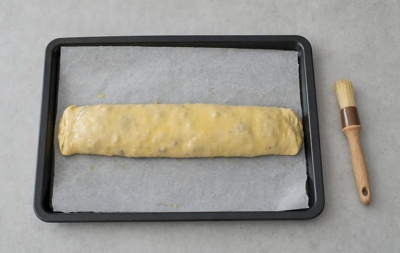 Apple Strudel, step 11: the strudel on the baking sheet, brushed with melted butter