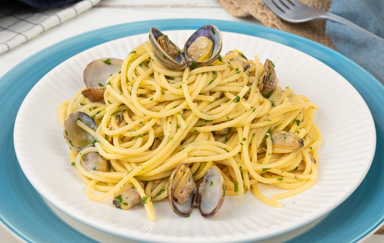 Plated spaghetti alle vongole sprinkled with fresh parsley