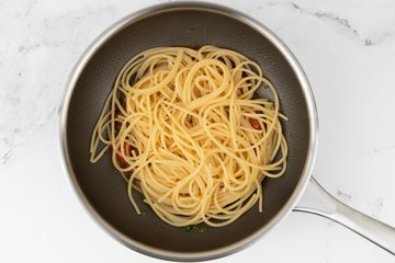 Spaghetti with Clams and Cherry Tomatoes, preparation 8: clams added to the spaghetti in the pan