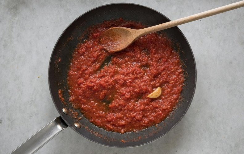 Spinach Tortelli with Ricotta and Parmigiano, step 6: tomato sauce cooking in a skillet with garlic