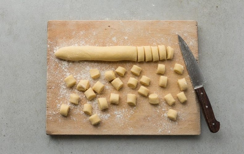 Struffoli, step 2: the dough rolled into ropes and cut into small pieces