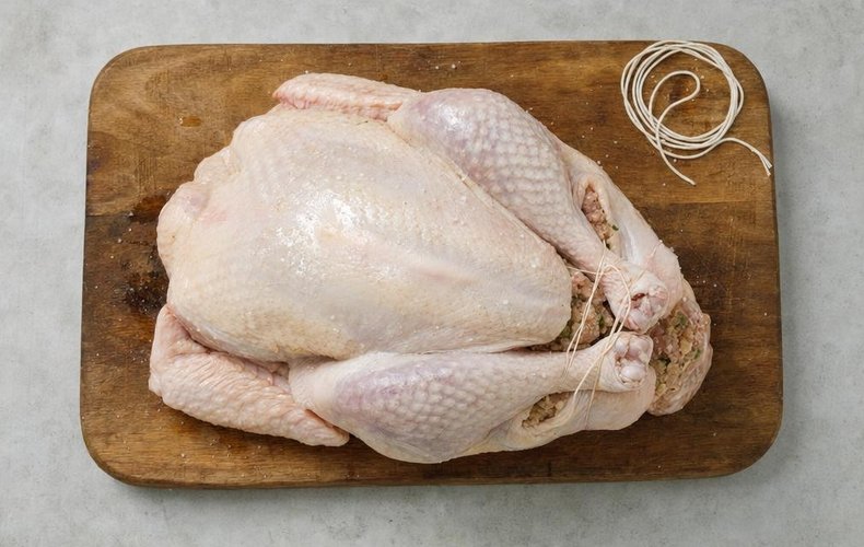 Stuffed Christmas Turkey, step 4: the turkey filled with stuffing and tied with kitchen twine