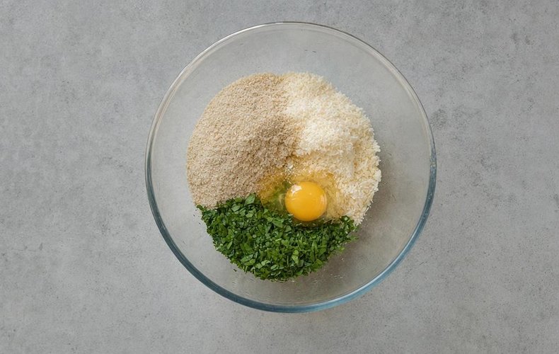Stuffed Roast Turkey Roll, step 1: breadcrumbs, grated Grana, egg and parsley in a bowl