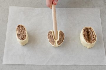Super Quick Nutella Brioches, step 3: pressing each slice with a wooden spoon handle
