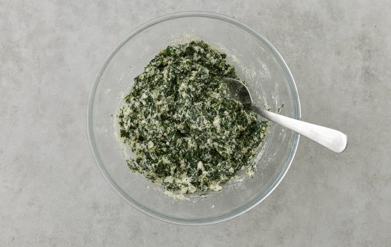 Swiss Chard and Ricotta Savory Pie, step 2: chopped Swiss chard mixed with ricotta and egg in a bowl