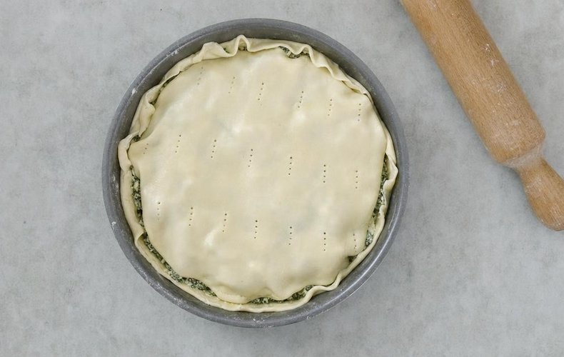 Swiss Chard and Ricotta Savory Pie, step 3: tart pan lined with dough and filled with the chard and ricotta