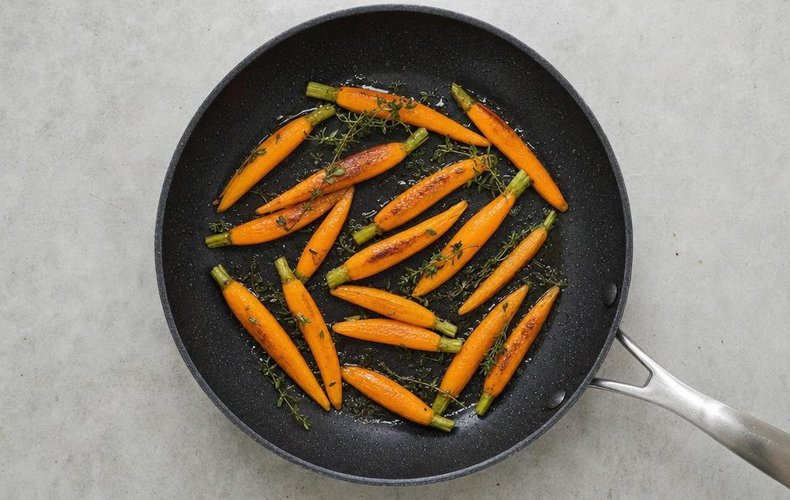 Thyme-Glazed Baby Carrots, step 3: carrots and thyme cooking in a nonstick skillet