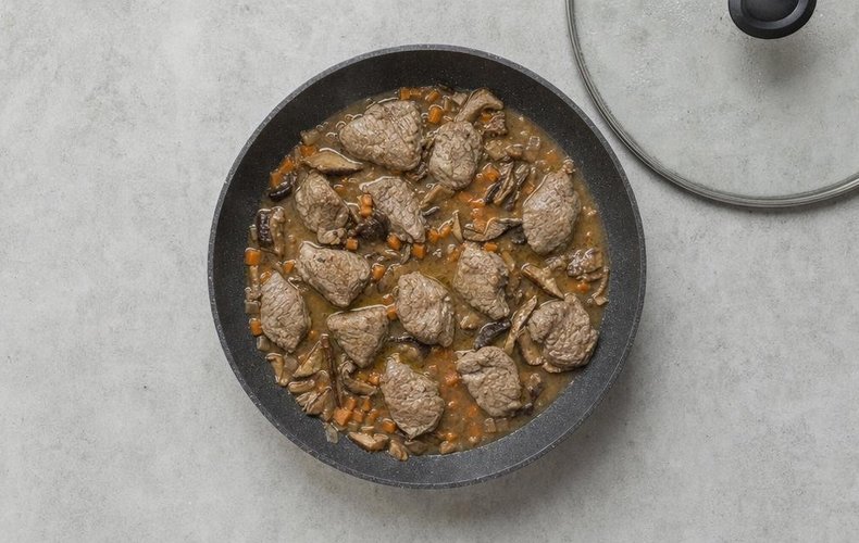 Veal Cheeks with White Wine and Porcini, step 3: veal cheeks braising with porcini mushrooms