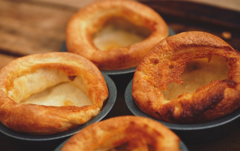 Golden Yorkshire puddings baked in a muffin pan